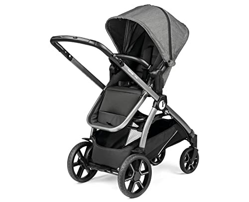 A modern baby stroller with a gray canopy and black seat.