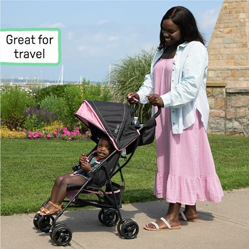 Woman pushing a stroller with a child outdoors, with a 'Great for travel' sign.